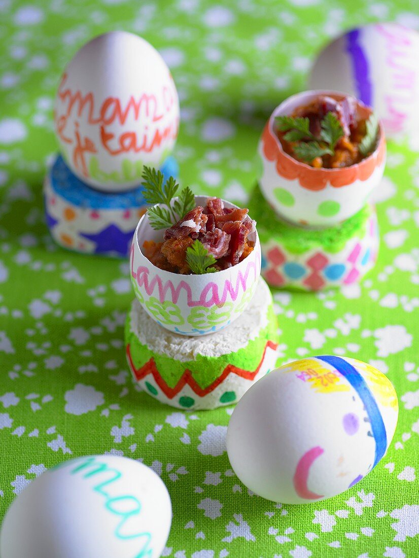 Painted eggshells filled with vegetables and bacon