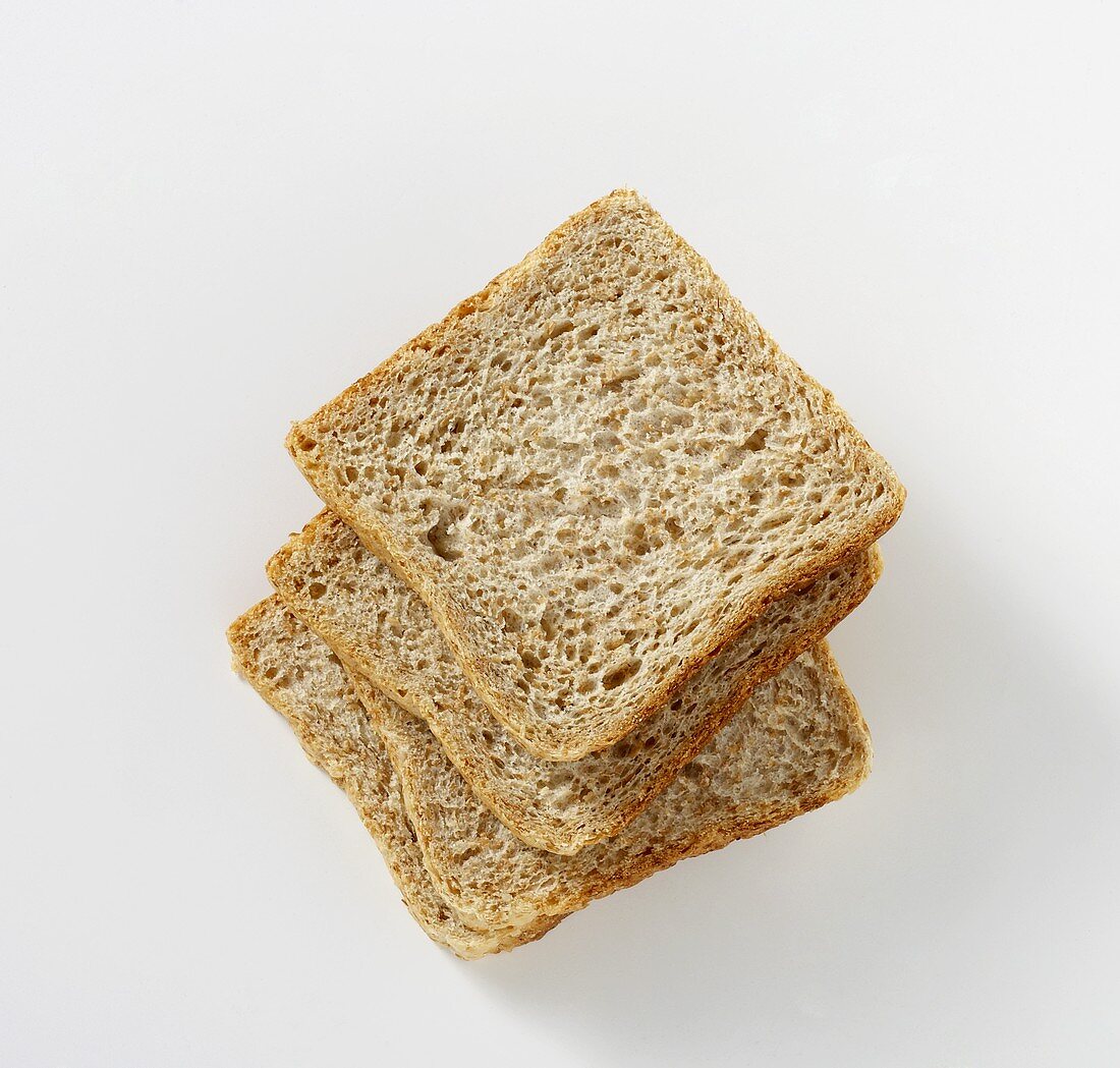 Four slices of wholemeal bread, stacked