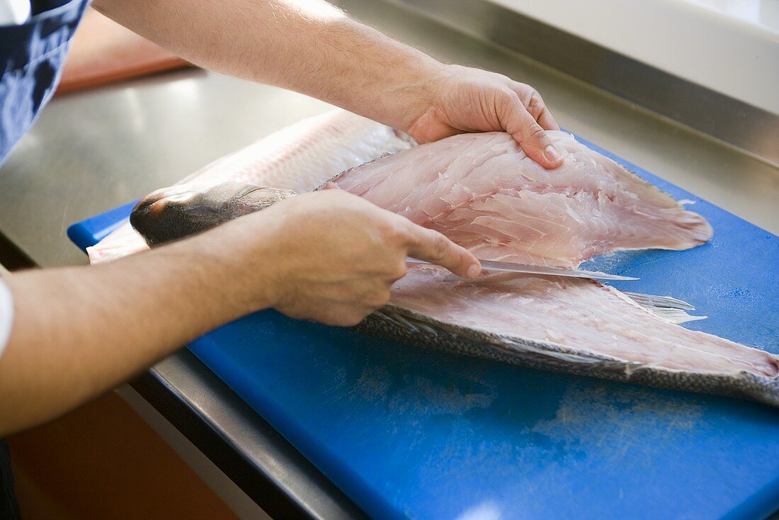 Man filleting a sea bass