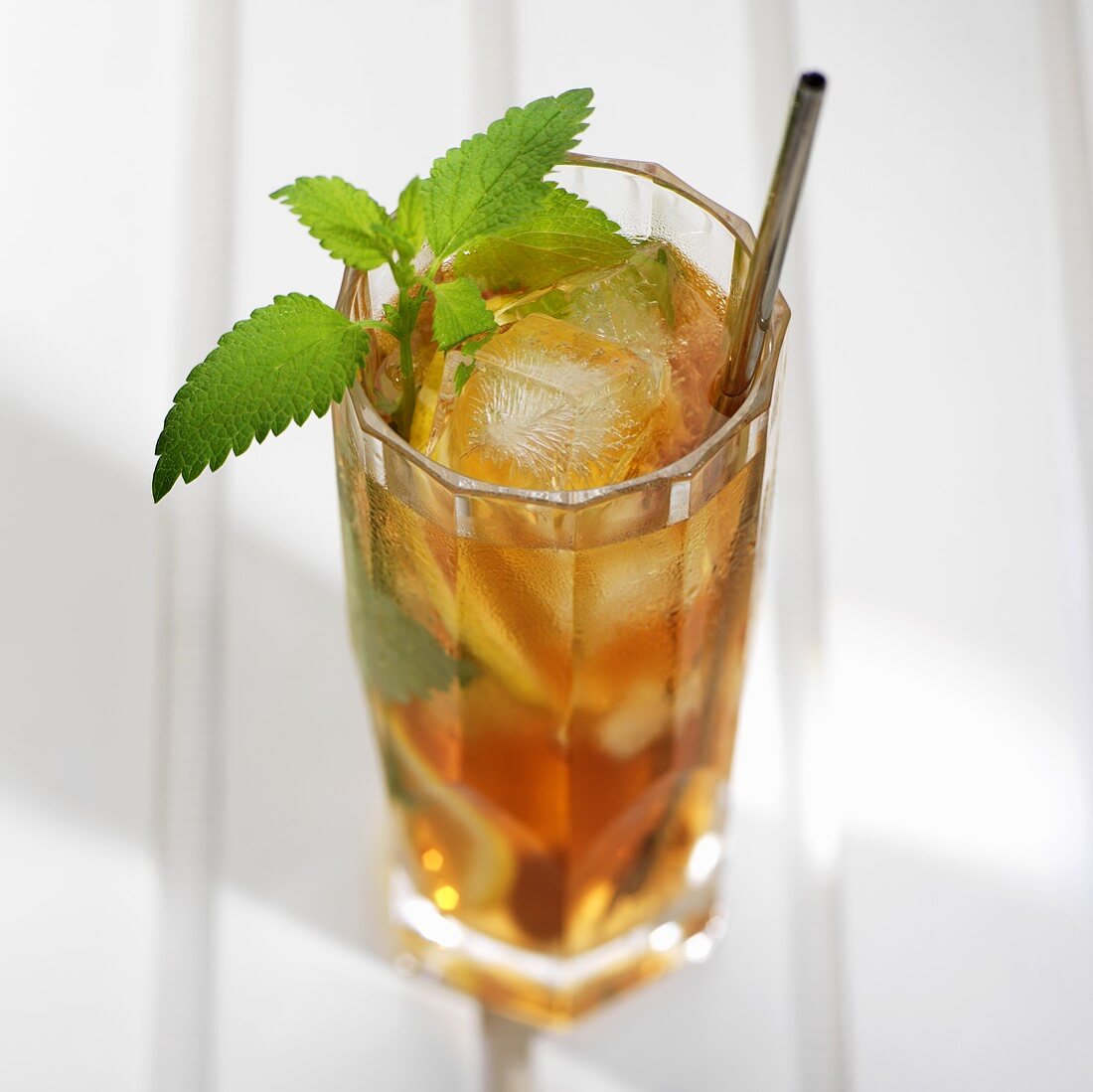 A glass of mint tea with ice cubes