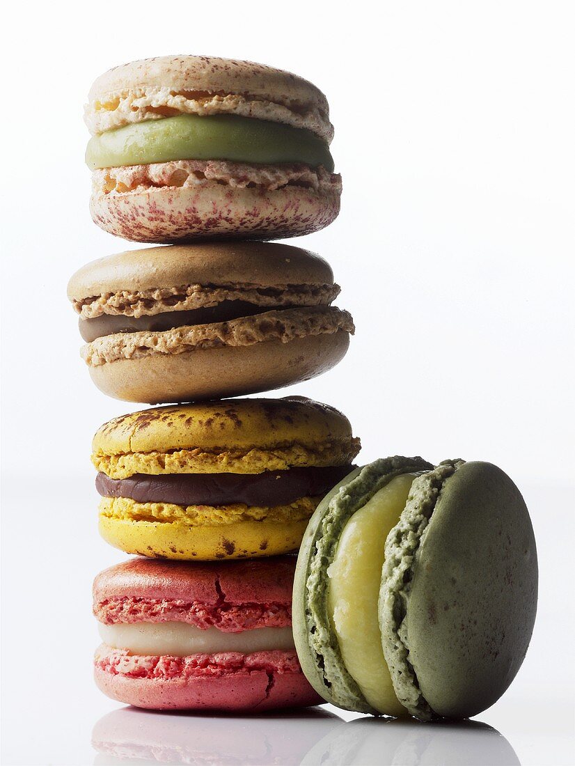 Different coloured macarons, stacked (small French cakes)