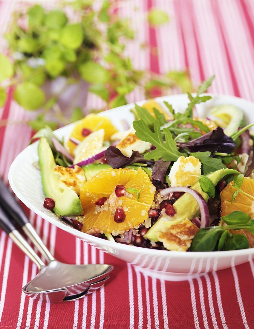 Quinoa salad with avocado, orange, onion, rocket, vegan cheese