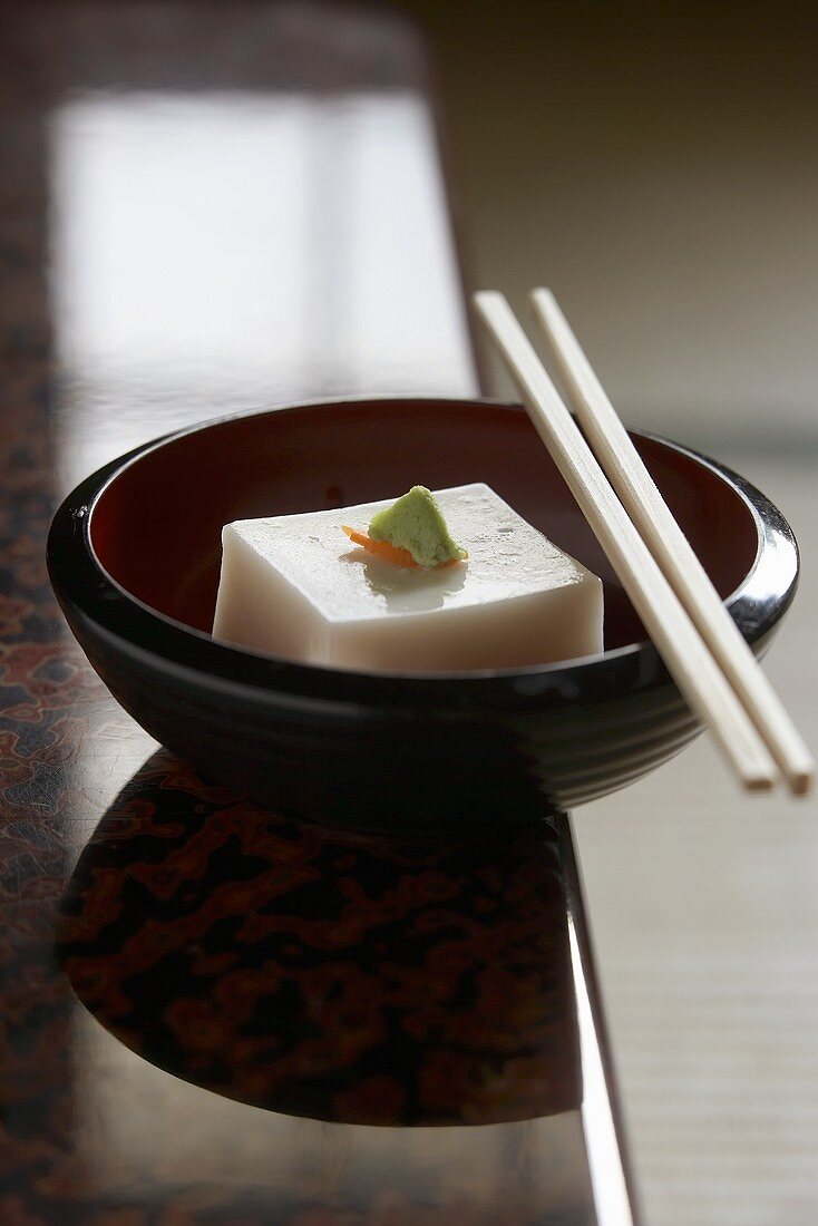 Tofu in a bowl with chopsticks