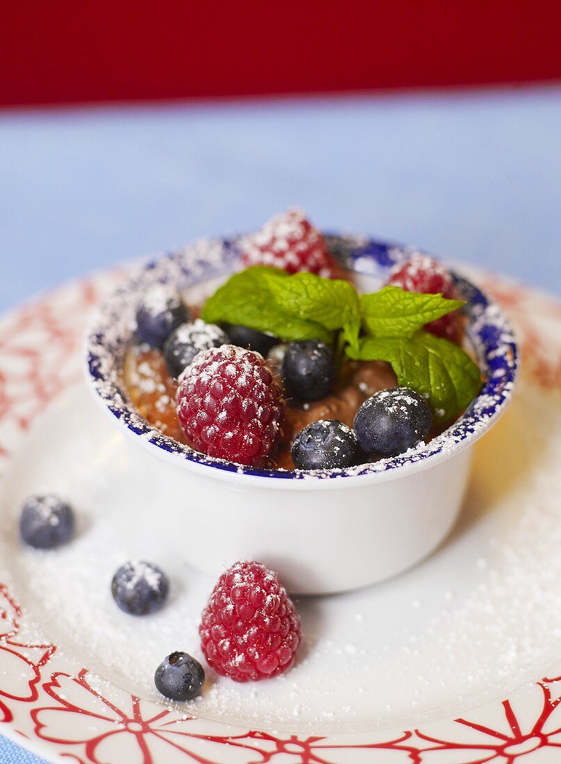 Mousse au chocolat mit frischen Him- und Heidelbeeren