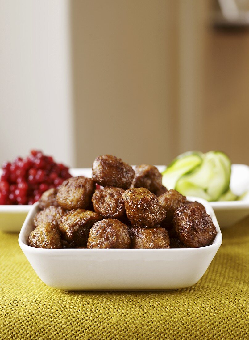 Meatballs with cucumber salad and cranberries