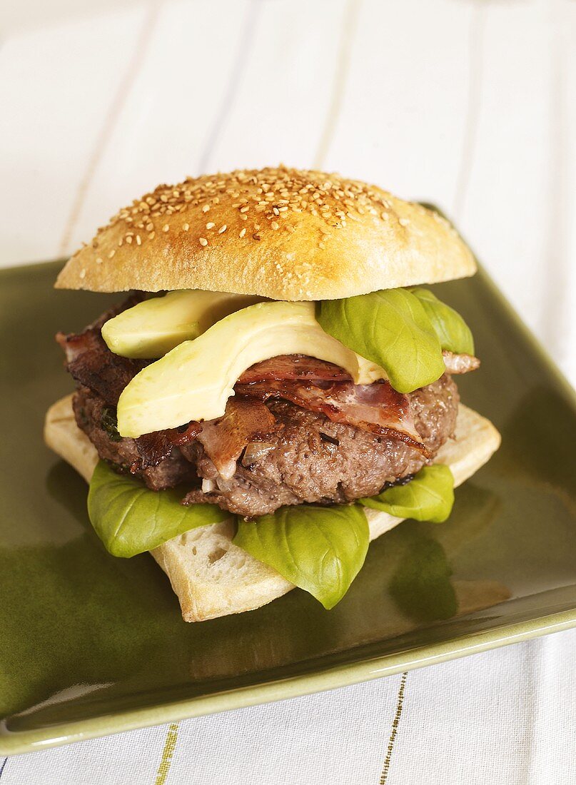Burger with bacon, basil and avocado