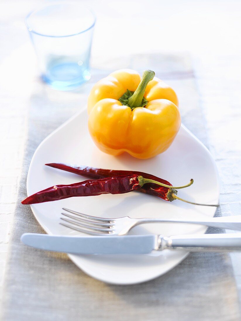 A yellow pepper and two dried chillies