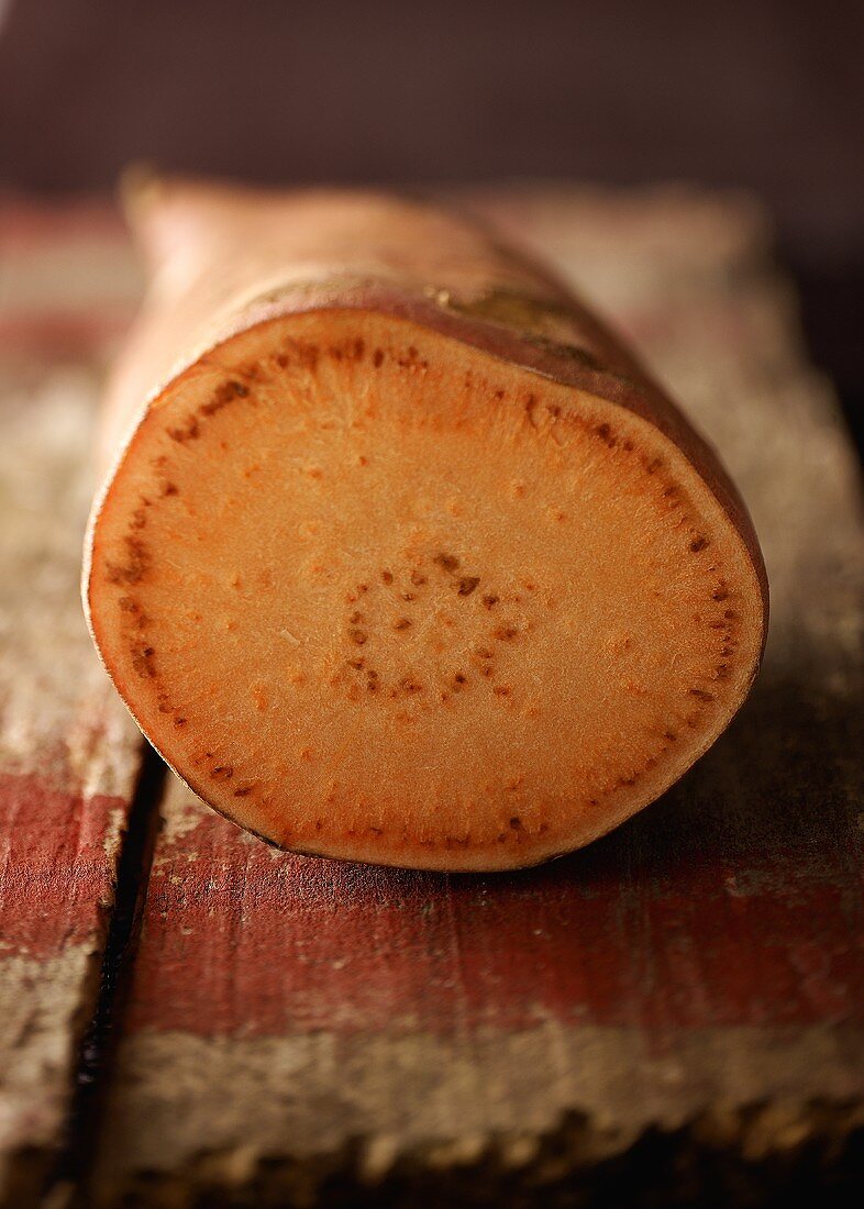 A sweet potato, showing a cut surface