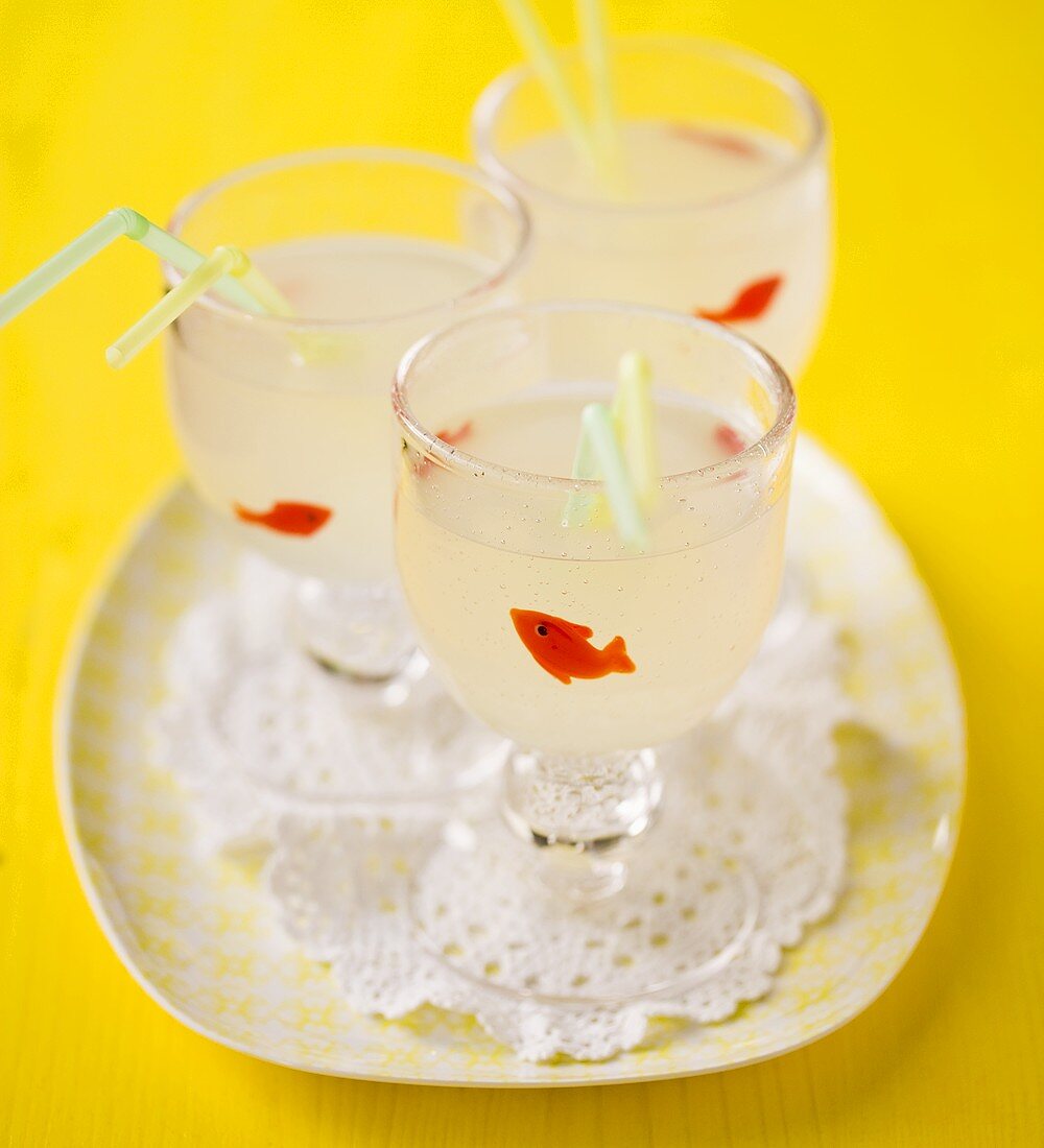 Three glasses of lemonade with straws