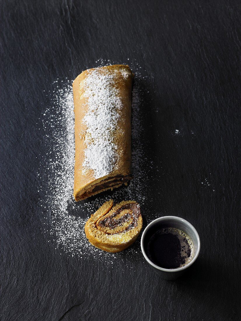 Coffee Swiss roll with nut cream filling & a cup of coffee