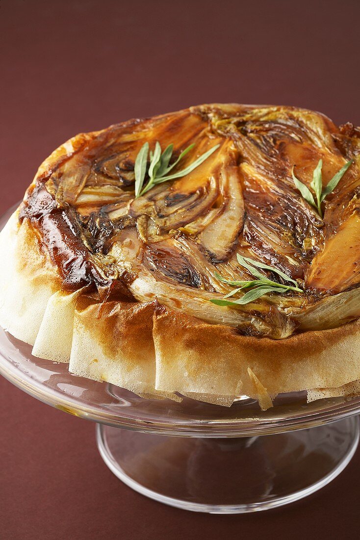 Chicory and goat's cheese Tarte Tatin on a cake stand
