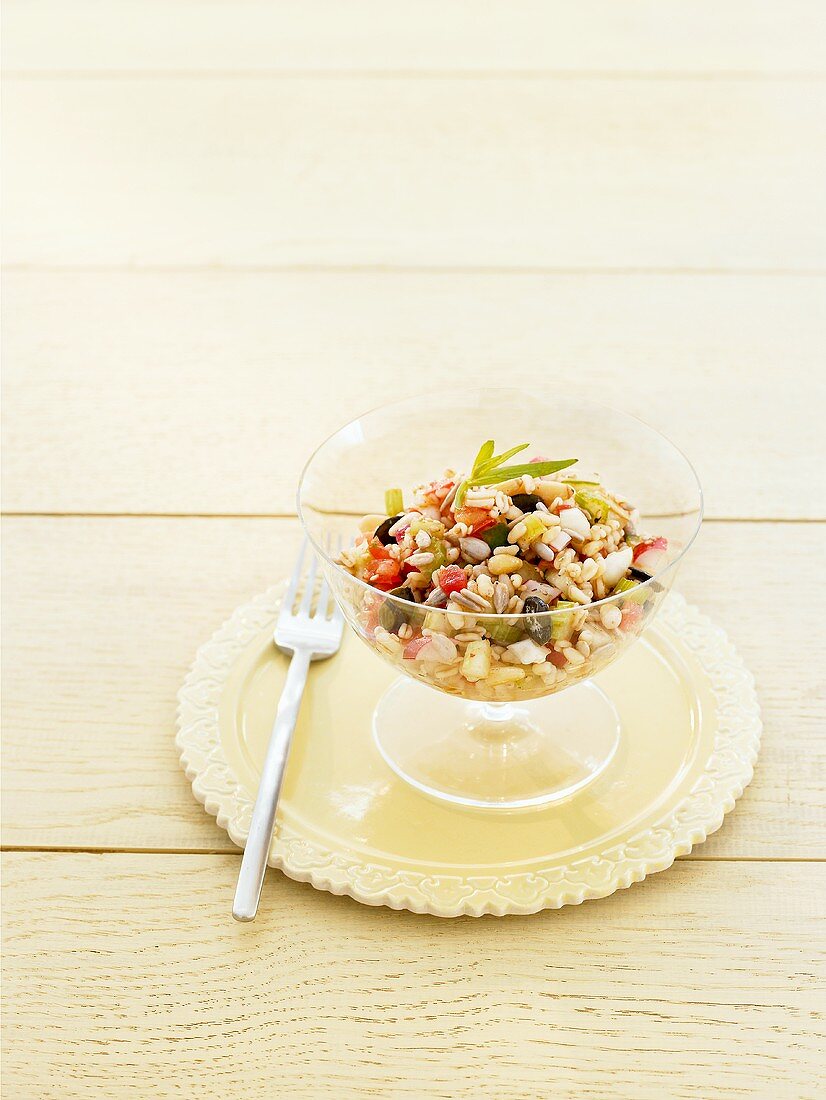 Dressed grain and vegetable salad in a glass