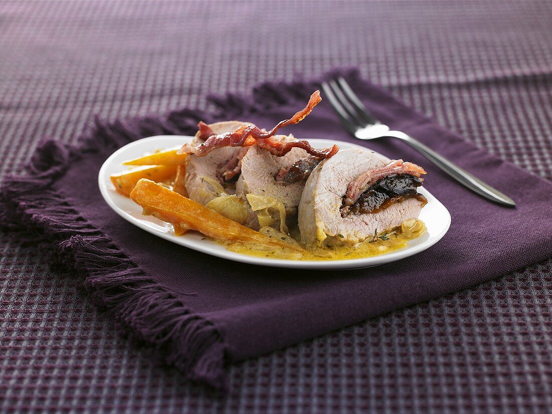 Pork fillet stuffed with bacon and prunes, carrots
