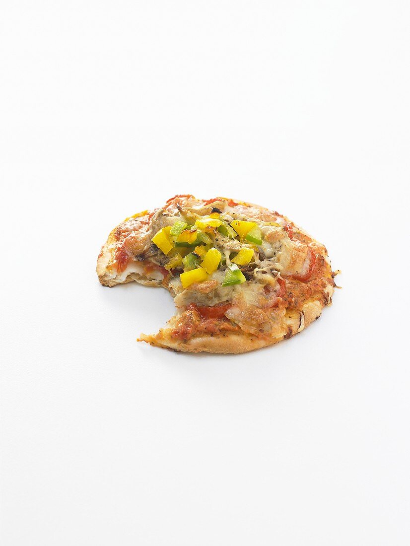 A vegetable pizza with a bite taken