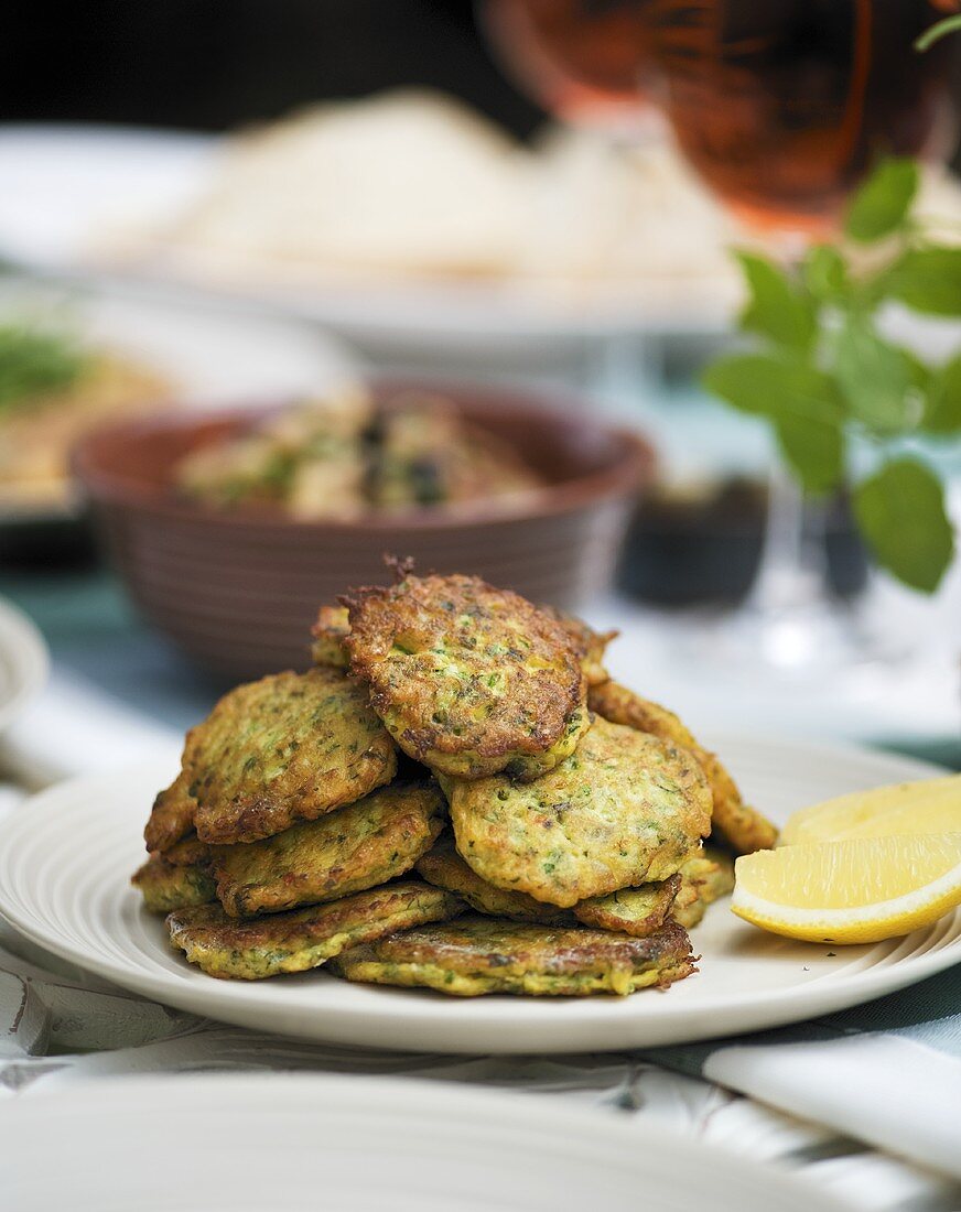 Courgette cakes with lemon wedges