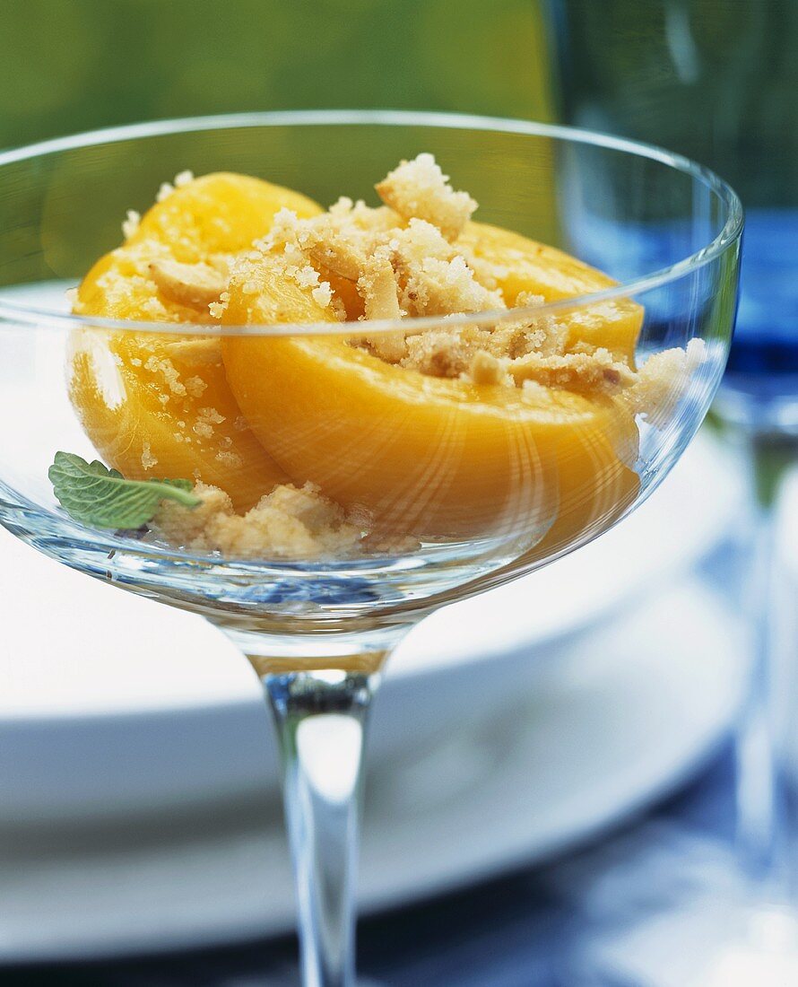 Peach with nuts and sugar in a glass