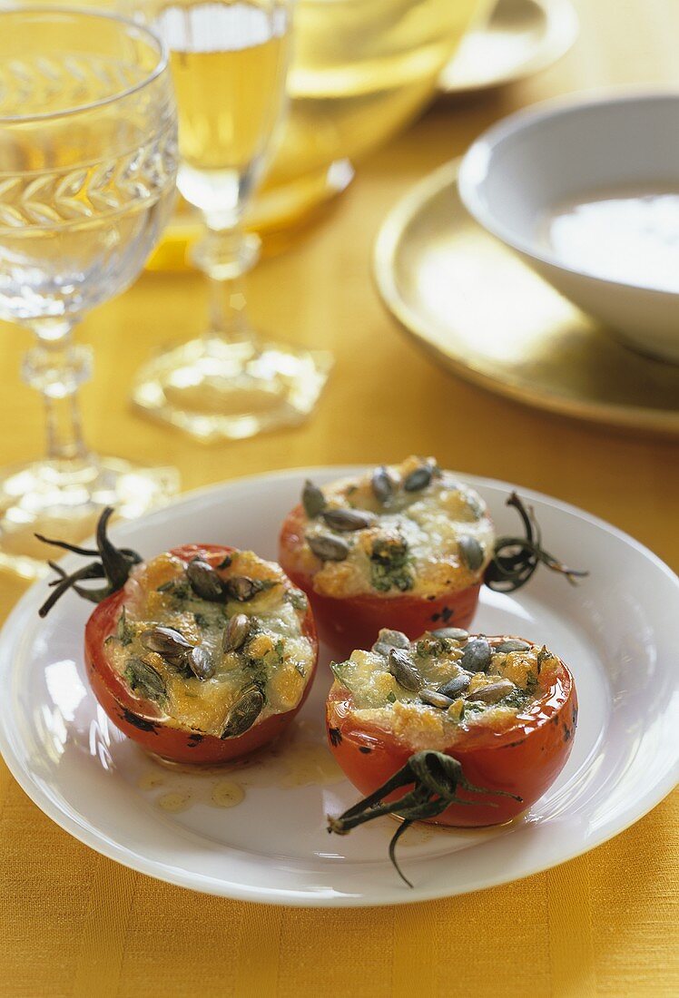 Baked tomatoes stuffed with pumpkin seeds and cheese