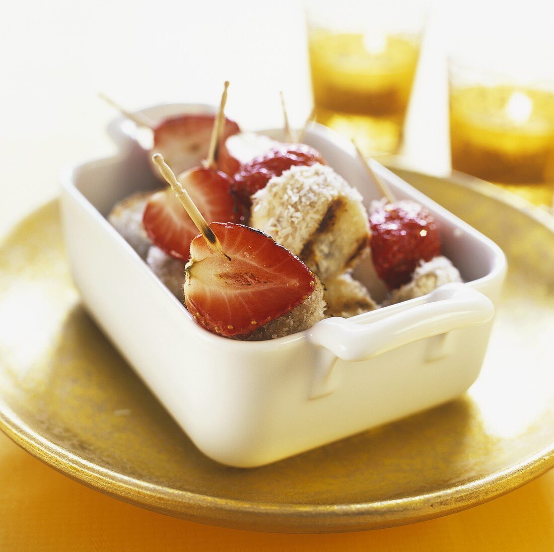 Grilled strawberries and coconut-coated bananas on skewers