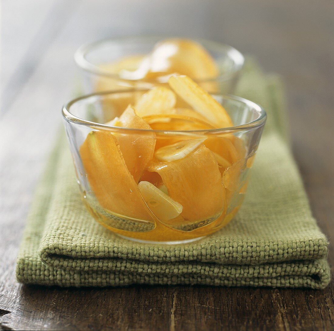 Carrot salad with garlic in two glass bowls