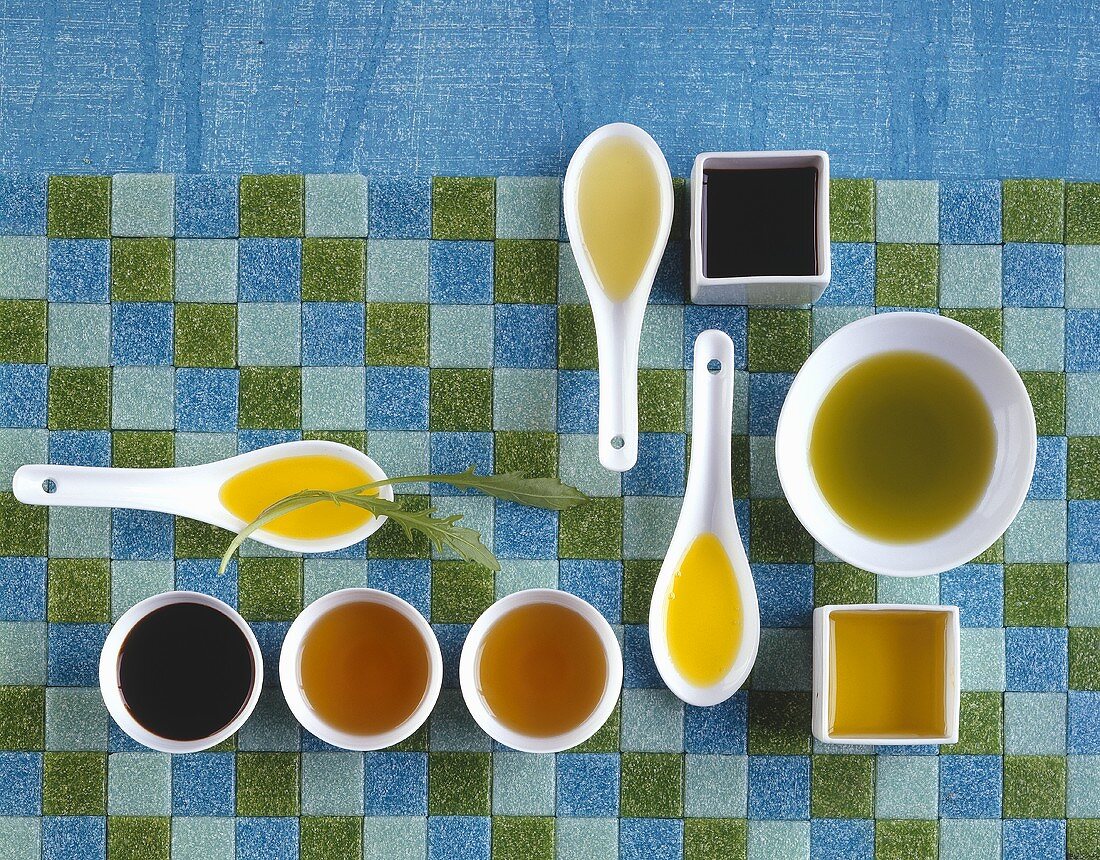 Various types of oil in spoons and dishes