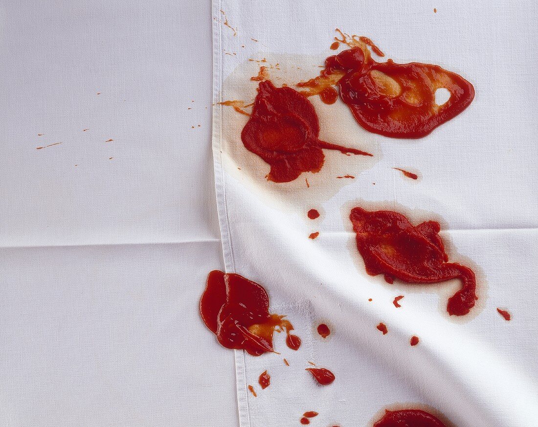 Blobs of ketchup on tablecloth