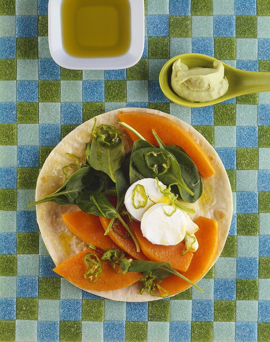 Slices of pumpkin, spinach & fresh goat's cheese on tortilla