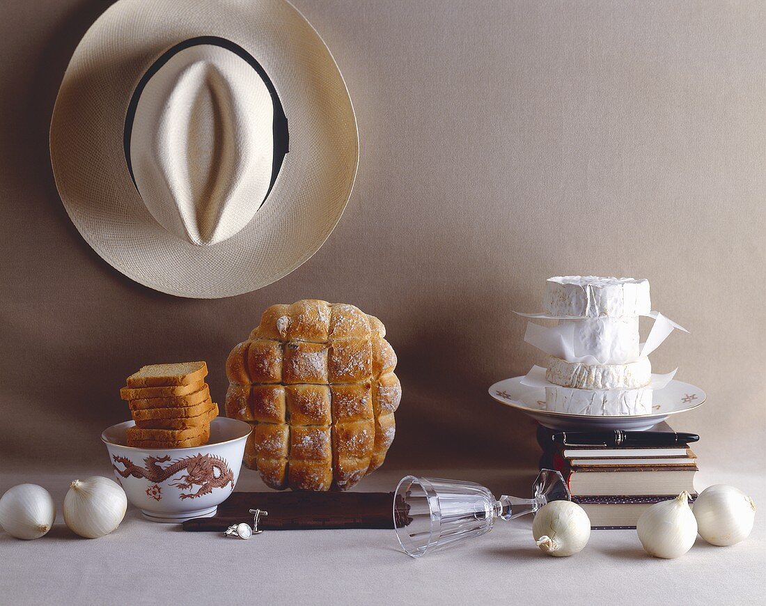 Elegant English still life with bread, cheese and hat