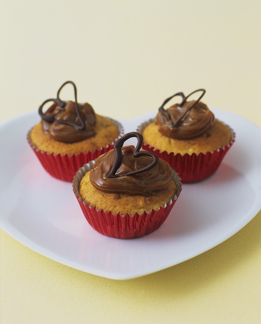 Three banana cupcakes with dulce de leche topping