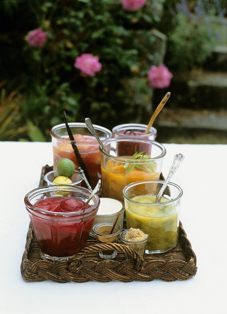Assorted fruit compotes in glasses on a tray