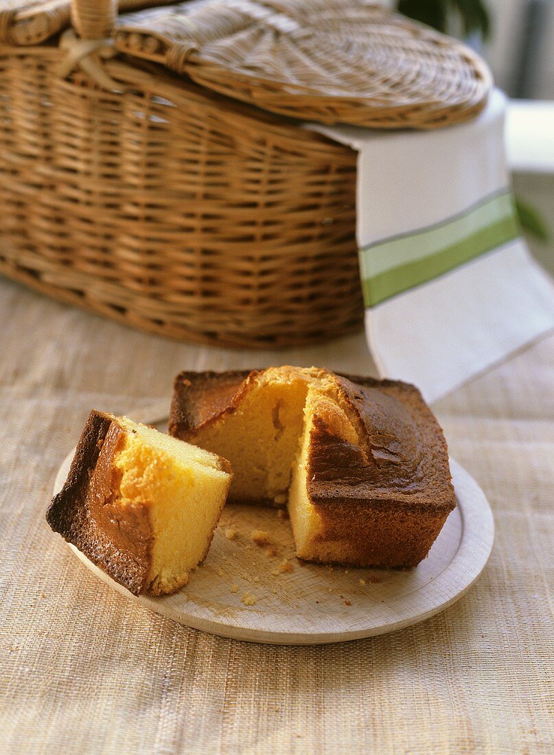 Pound cake, a piece cut, with a picnic basket