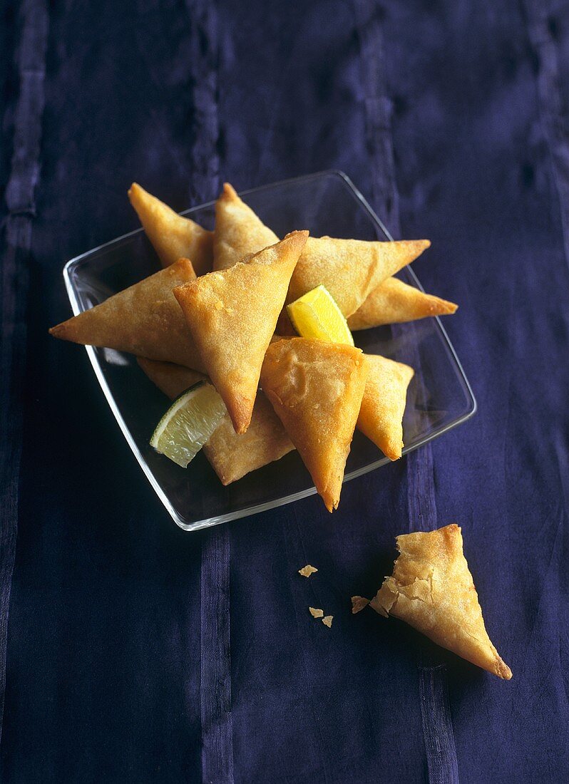 Deep-fried cheese and herb pasties with lime