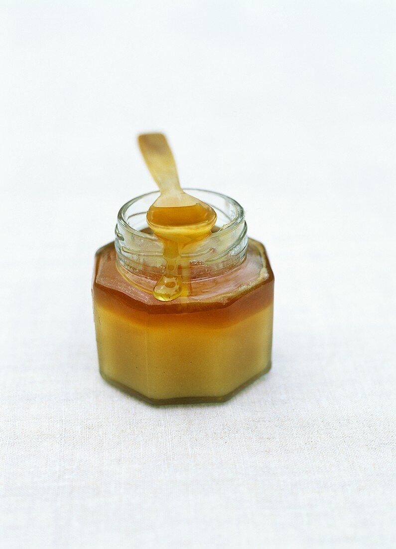 A jar of honey with spoon