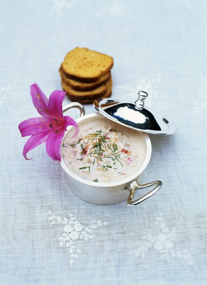 A pot of crab spread with toast