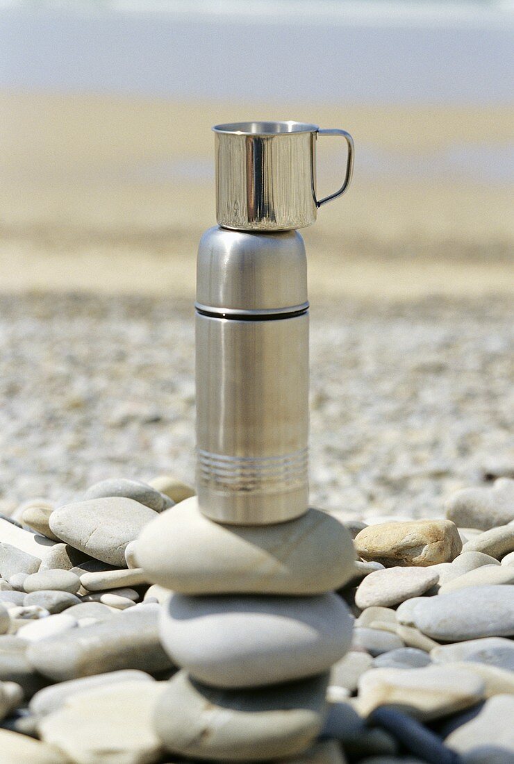 Thermos flask on pebbles