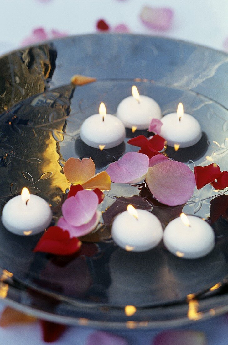 Floating candles and rose petals in a bowl