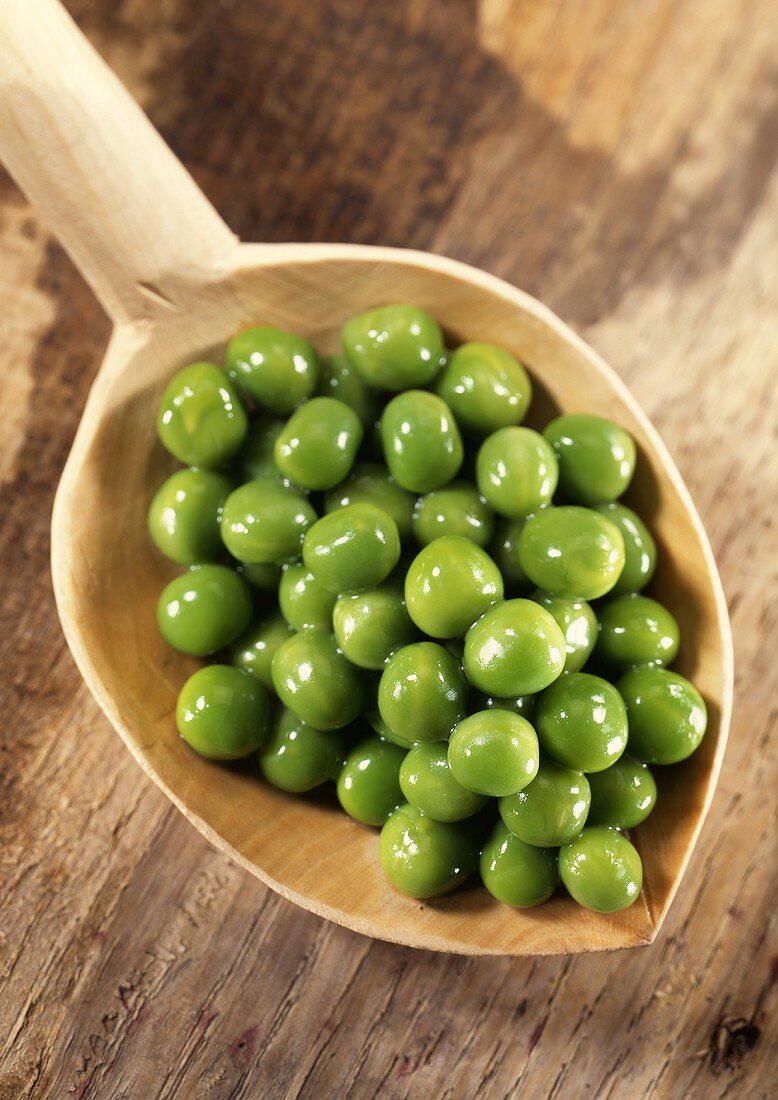 Peas on a wooden spoon