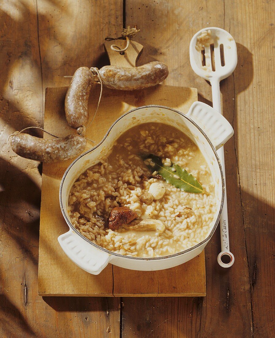 Mushroom risotto in heart-shaped pan, sausages