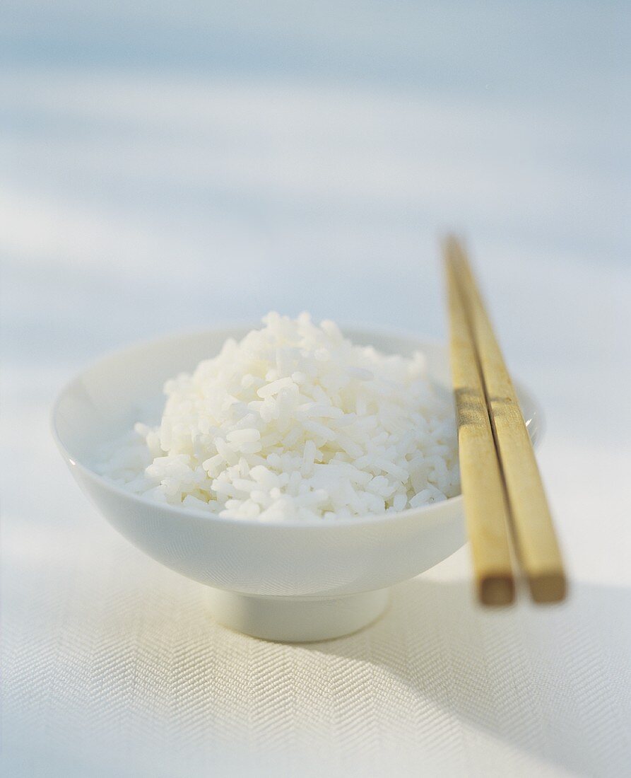 Ein Schälen Reis mit Essstäbchen