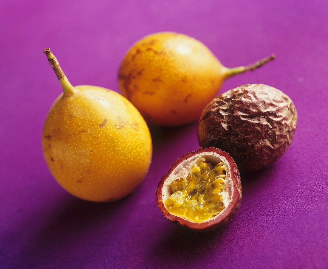 Whole golden passion fruits & whole & half purple passion fruit