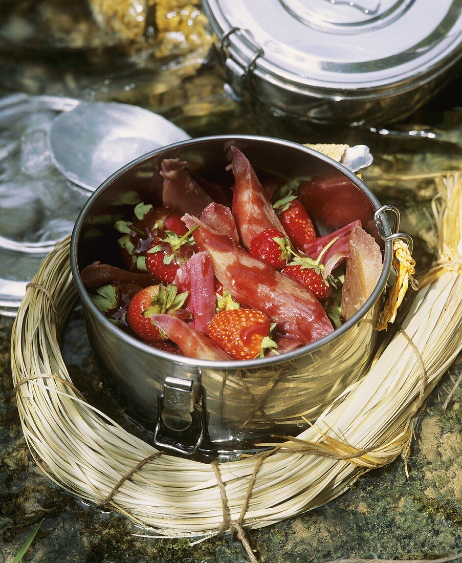 Rhubarb with strawberries & strawberry sauce in picnic container