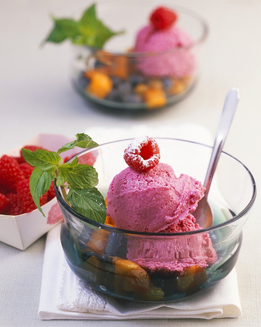 Raspberry ice cream on berries and apricots