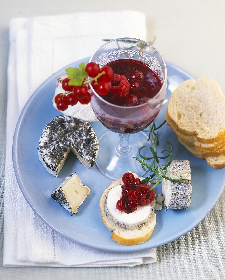 Different goats' cheeses with berry confit and baguette