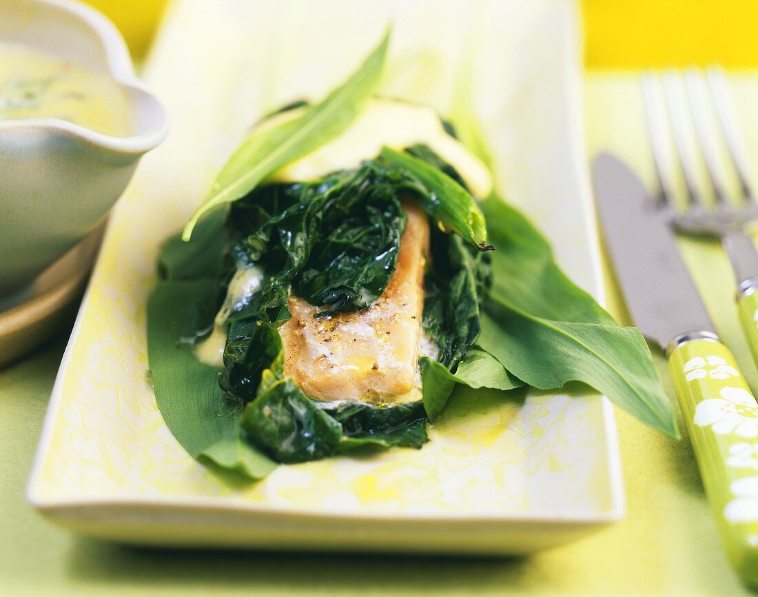 Spinach-wrapped salmon with ramsons (wild garlic)