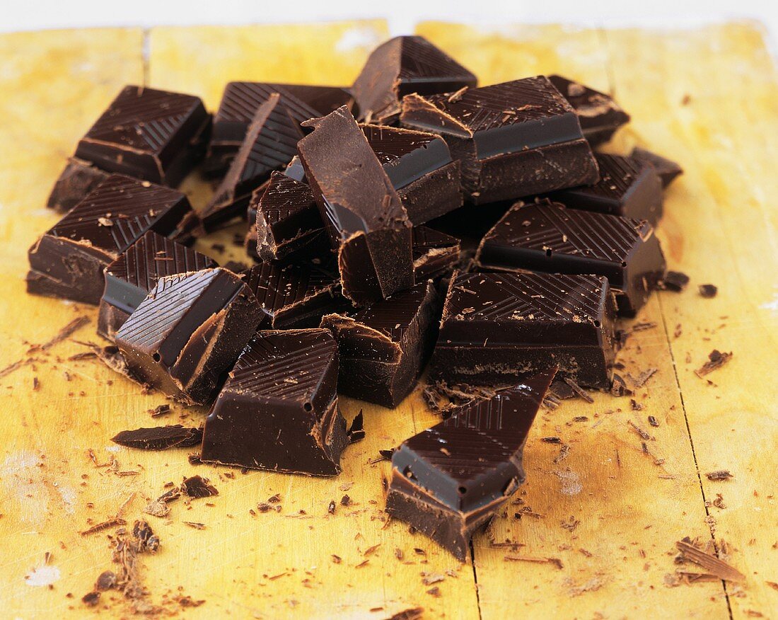Chopped dark chocolate on a wooden board