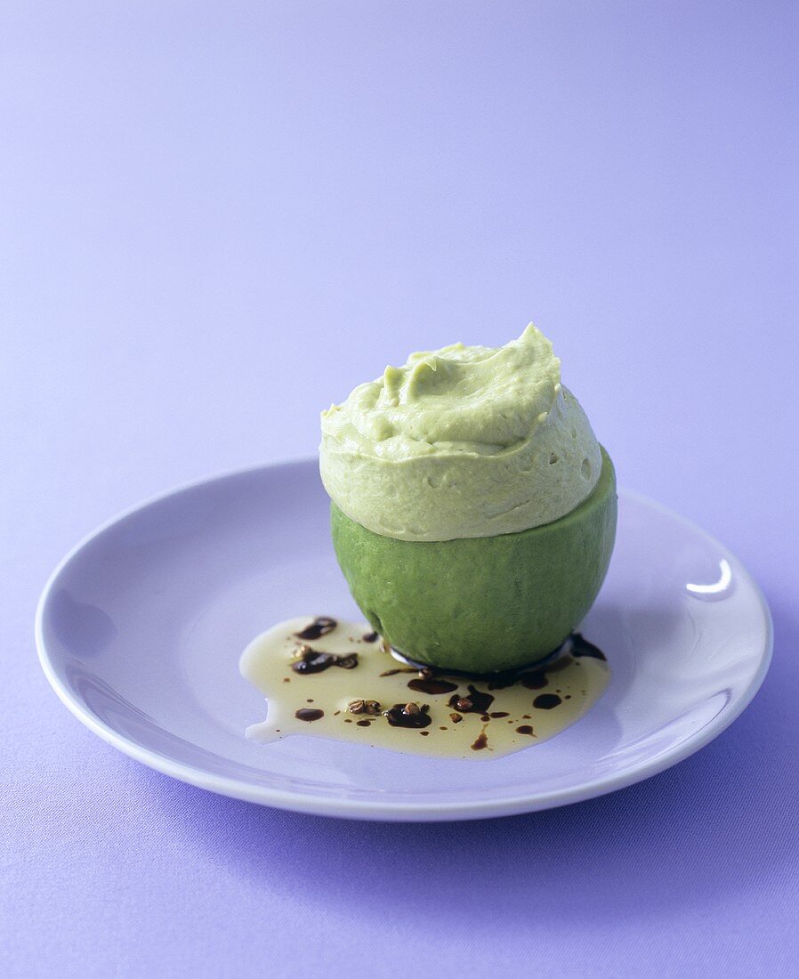 Avocado mousse in an avocado with coriander dressing