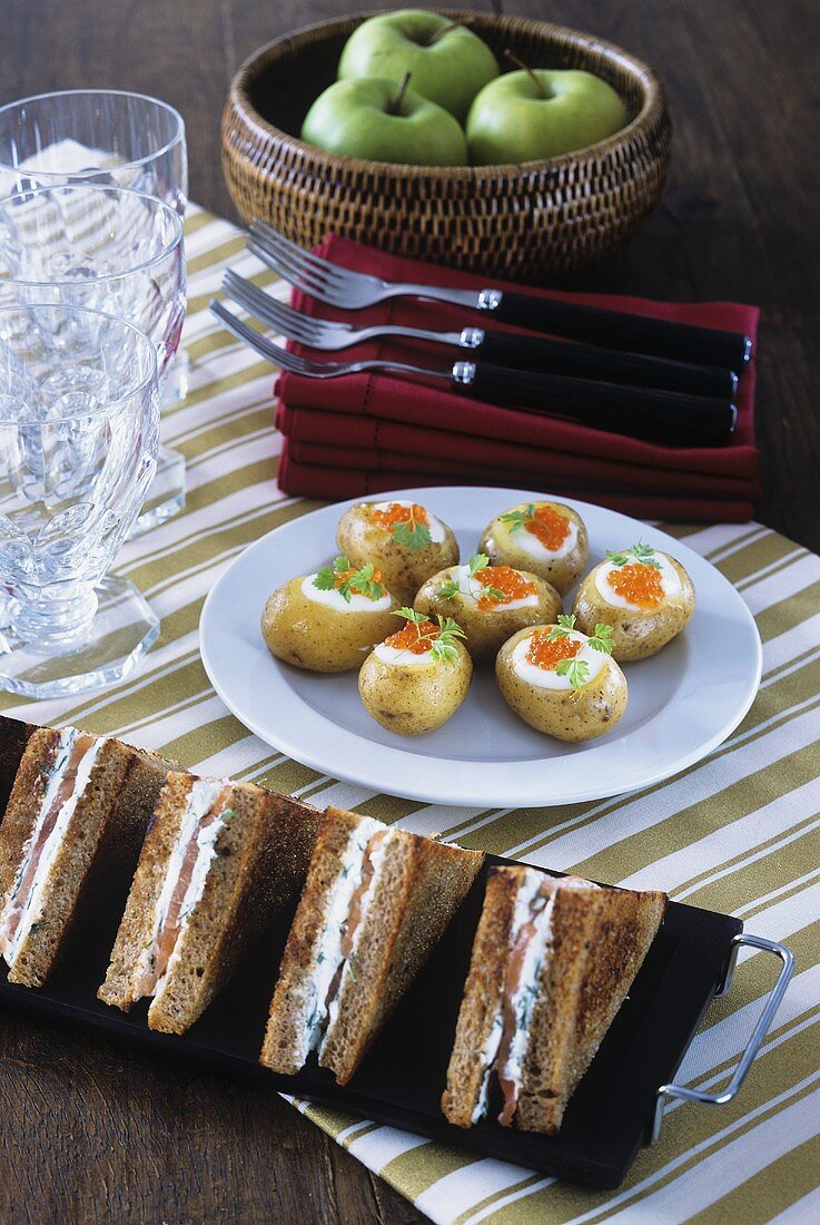 Salmon sandwiches and potatoes with salmon caviar