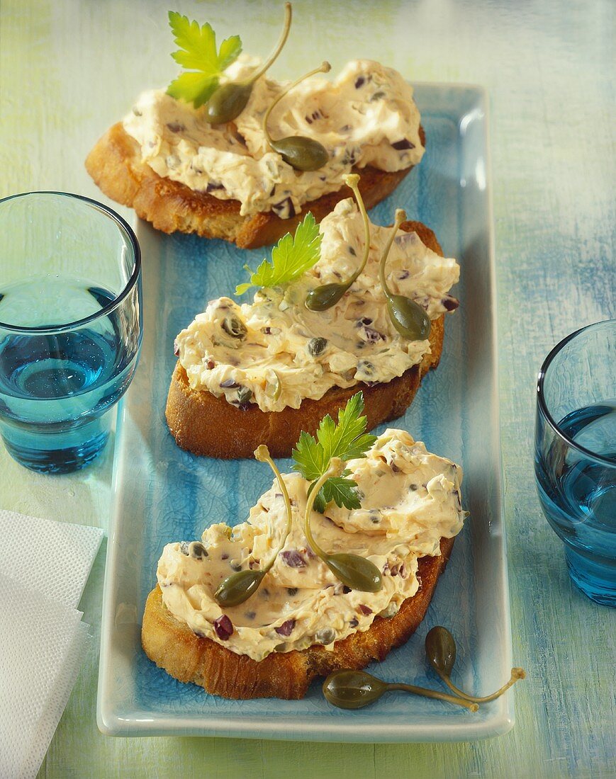 Crostini with soft cheese and olive spread