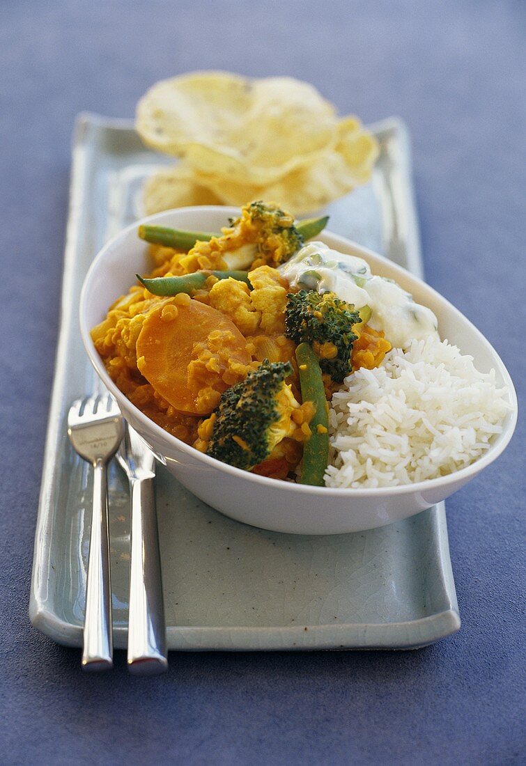 Lentil and vegetable curry with ginger yoghurt and rice