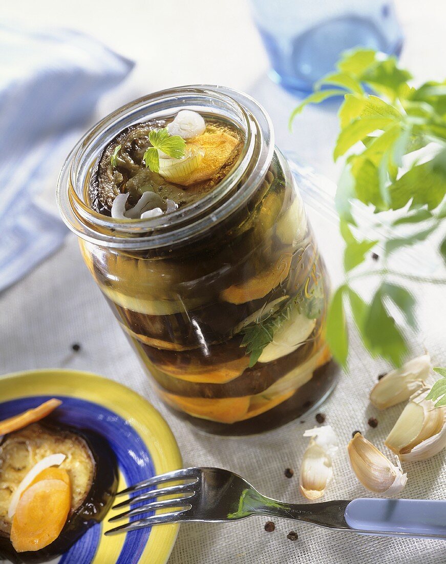 Pickled aubergine with carrot and onion in preserving jar
