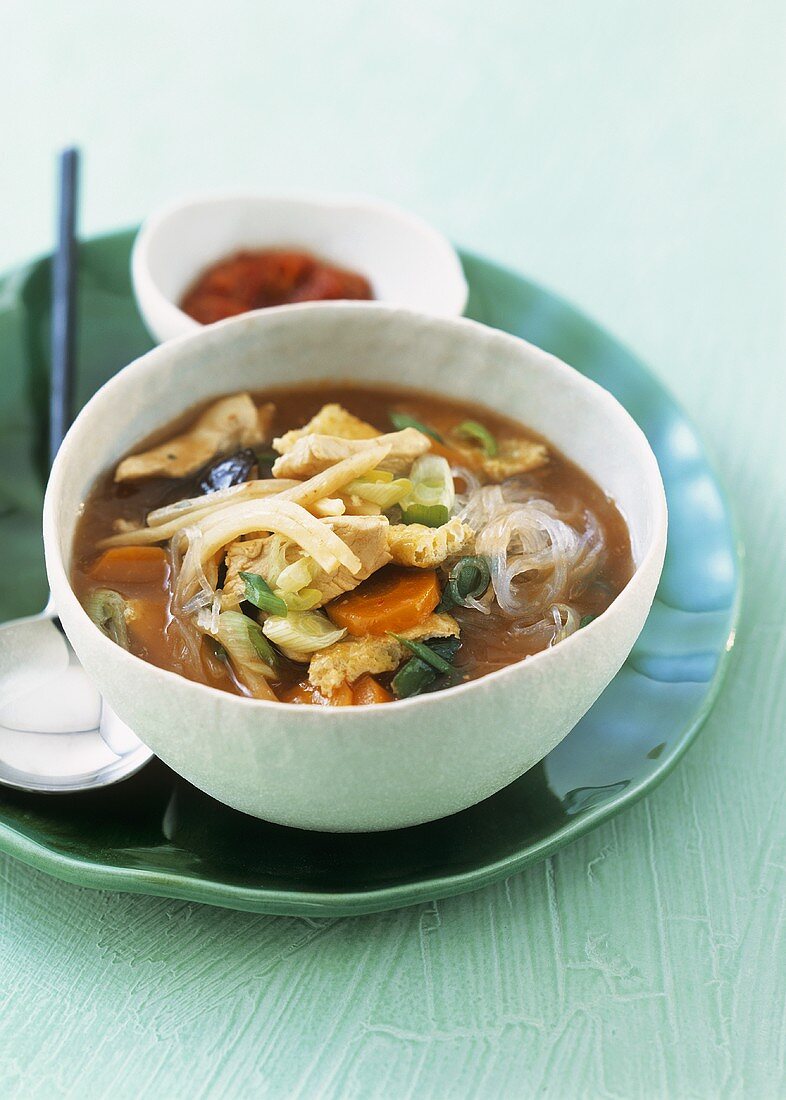 Hot and sour Asian soup with chicken breast and vegetables